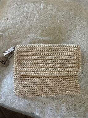 NWOT, The Sak crochet zip pouch in creme .